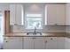 Kitchen showcasing white cabinets, granite countertops, stainless appliances, and a view to the sink at 4319 Silver Peak Pkwy, Suwanee, GA 30024