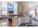 Spacious living room with fireplace, tall windows, hardwood floors, and an adjacent eat-in kitchen at 4319 Silver Peak Pkwy, Suwanee, GA 30024