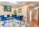 Comfortable living room featuring hardwood floors, bright windows, and stylish blue sofas at 4319 Silver Peak Pkwy, Suwanee, GA 30024