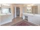 Spacious bathroom with double vanities and stylish tile flooring at 4319 Silver Peak Pkwy, Suwanee, GA 30024