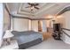 Bright primary bedroom featuring crown molding, a ceiling fan, and plush carpeting at 4319 Silver Peak Pkwy, Suwanee, GA 30024