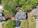 An aerial shot showcases the house's roof, backyard deck, driveway, and surrounding landscaping at 4360 Havenridge Pl, Cumming, GA 30041