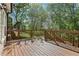 Large wooden deck offers an outdoor space for relaxation and entertaining overlooking a lush green yard at 4360 Havenridge Pl, Cumming, GA 30041