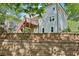 Backyard view features a wooden deck and retaining wall, offering outdoor living space and landscaped aesthetics at 4360 Havenridge Pl, Cumming, GA 30041