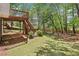 Backyard featuring a lush green lawn, an elevated deck, and mature trees creating a private outdoor space at 4360 Havenridge Pl, Cumming, GA 30041