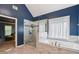 Bright bathroom featuring a marble tiled floor, a tub and a glass enclosed shower with a tiled accent wall at 4360 Havenridge Pl, Cumming, GA 30041