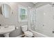 Bright bathroom featuring white vanity, toilet, shower, tub combination with a window at 4360 Havenridge Pl, Cumming, GA 30041