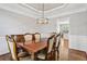 Dining room features wood floors, modern lighting, and opens into the kitchen at 4360 Havenridge Pl, Cumming, GA 30041