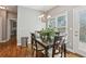 Inviting dining room featuring hardwood floors, a modern chandelier, and large window with a view to the backyard at 4360 Havenridge Pl, Cumming, GA 30041