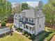 An eye-level exterior view showcases a grey home with mature landscaping and a two-car garage at 4360 Havenridge Pl, Cumming, GA 30041
