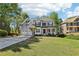 Charming two-story home featuring a manicured lawn, stone accents, and a two-car garage with mature landscaping at 4360 Havenridge Pl, Cumming, GA 30041