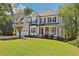 Charming two-story home featuring a manicured lawn, stone accents, and a two-car garage with mature landscaping at 4360 Havenridge Pl, Cumming, GA 30041