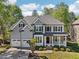 Traditional home featuring a two-car garage, manicured front lawn, and classic architectural details at 4360 Havenridge Pl, Cumming, GA 30041