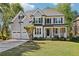Charming two-story home featuring a manicured lawn, stone accents, and a two-car garage with mature landscaping at 4360 Havenridge Pl, Cumming, GA 30041