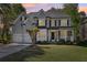 Inviting home featuring a covered porch, manicured lawn, and an attached two-car garage at 4360 Havenridge Pl, Cumming, GA 30041