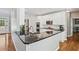 Modern kitchen featuring white cabinets, stainless steel appliances, and a black granite countertop at 4360 Havenridge Pl, Cumming, GA 30041
