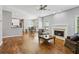 Open-concept living room with hardwood floors, a fireplace, neutral paint, connecting to the kitchen and dining areas at 4360 Havenridge Pl, Cumming, GA 30041