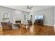 Cozy living room with hardwood floors, a fireplace, neutral paint, and large windows offering ample natural light at 4360 Havenridge Pl, Cumming, GA 30041