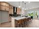 Open concept kitchen with stainless steel appliances, quartz countertops, and a large island with seating at 439 Mezzo Ln # 88, Alpharetta, GA 30009