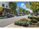 Street view of shops and restaurants in Avalon, with sidewalks, street parking, and planters with colorful flowers at 439 Mezzo Ln # 88, Alpharetta, GA 30009