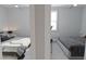 The bedroom has two double beds and a neutral color scheme to create a relaxing ambiance at 439 Mezzo Ln # 88, Alpharetta, GA 30009