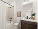 Well-lit bathroom with modern fixtures, shower and tub combo, and vanity at 654 Soul Aly # 102, Alpharetta, GA 30009