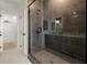 Modern bathroom features a sleek shower with a glass door and an attached walk-in closet at 654 Soul Aly # 102, Alpharetta, GA 30009