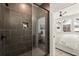 Modern bathroom featuring a tiled shower with a glass door and bedroom access at 654 Soul Aly # 102, Alpharetta, GA 30009