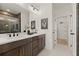 Bathroom with a double sink vanity, large mirror, and a walk-in shower with glass door at 654 Soul Aly # 102, Alpharetta, GA 30009