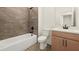 Bathroom featuring modern bathtub, tiling, vanity and lighting at 654 Soul Aly # 102, Alpharetta, GA 30009