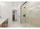 Modern bathroom with walk-in shower, marble tiling and wooden vanity with black hardware at 654 Soul Aly # 102, Alpharetta, GA 30009
