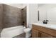 Modern bathroom features updated vanity, toilet, and tiled shower and tub combo at 654 Soul Aly # 102, Alpharetta, GA 30009