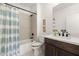 Stylish bathroom featuring a shower-tub combo with tiled walls, modern vanity, and a light blue striped curtain at 654 Soul Aly # 102, Alpharetta, GA 30009