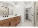 Bathroom with double sink vanity, walk-in closet, and glass shower with white marble walls at 654 Soul Aly # 102, Alpharetta, GA 30009