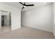 Spacious bedroom with neutral carpet, a ceiling fan, and access to a bathroom at 654 Soul Aly # 102, Alpharetta, GA 30009