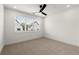 Bright bedroom featuring a ceiling fan and a large window with neighborhood views at 654 Soul Aly # 102, Alpharetta, GA 30009