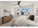 Bright bedroom with a modern area rug and triple windows, showcasing a bright and airy atmosphere at 654 Soul Aly # 102, Alpharetta, GA 30009