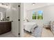 Well-lit bedroom with a bathroom and a large window providing lots of natural light at 654 Soul Aly # 102, Alpharetta, GA 30009