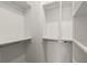 Walk-in closet with custom shelving and ample storage space at 654 Soul Aly # 102, Alpharetta, GA 30009