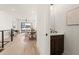Modern entryway with open floor plan and a powder room featuring a dark vanity at 654 Soul Aly # 102, Alpharetta, GA 30009