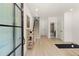 A bright entryway features hardwood floors, minimalist decor, stairs to the second level, and a glimpse of the bathroom at 654 Soul Aly # 102, Alpharetta, GA 30009