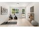 Bright exercise room has a stationary bike, yoga mat, and large window offering a view of the outdoors at 654 Soul Aly # 102, Alpharetta, GA 30009