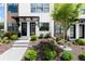 Townhome landscaped front yard featuring a concrete walkway and well-maintained plantings at 654 Soul Aly # 102, Alpharetta, GA 30009