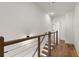 Hallway with wood floors and railing leading to another level in the home at 654 Soul Aly # 102, Alpharetta, GA 30009