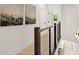 Hallway with hardwood floors and modern railings, leading to a view of the lower level at 654 Soul Aly # 102, Alpharetta, GA 30009