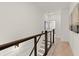 Upstairs hallway with modern railing and access to bedrooms at 654 Soul Aly # 102, Alpharetta, GA 30009