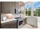 Chef's kitchen featuring stainless steel appliances and updated cabinetry with lots of light at 654 Soul Aly # 102, Alpharetta, GA 30009