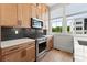 Kitchen featuring modern appliances, stainless steel stove, and ample cabinet space at 654 Soul Aly # 102, Alpharetta, GA 30009