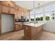 Modern kitchen with stainless steel appliances, an island, and bright light from windows at 654 Soul Aly # 102, Alpharetta, GA 30009