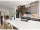 Modern kitchen island with pendant lighting, quartz countertop, and seating for four at 654 Soul Aly # 102, Alpharetta, GA 30009